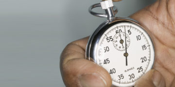 Human hand holding a stopwatch